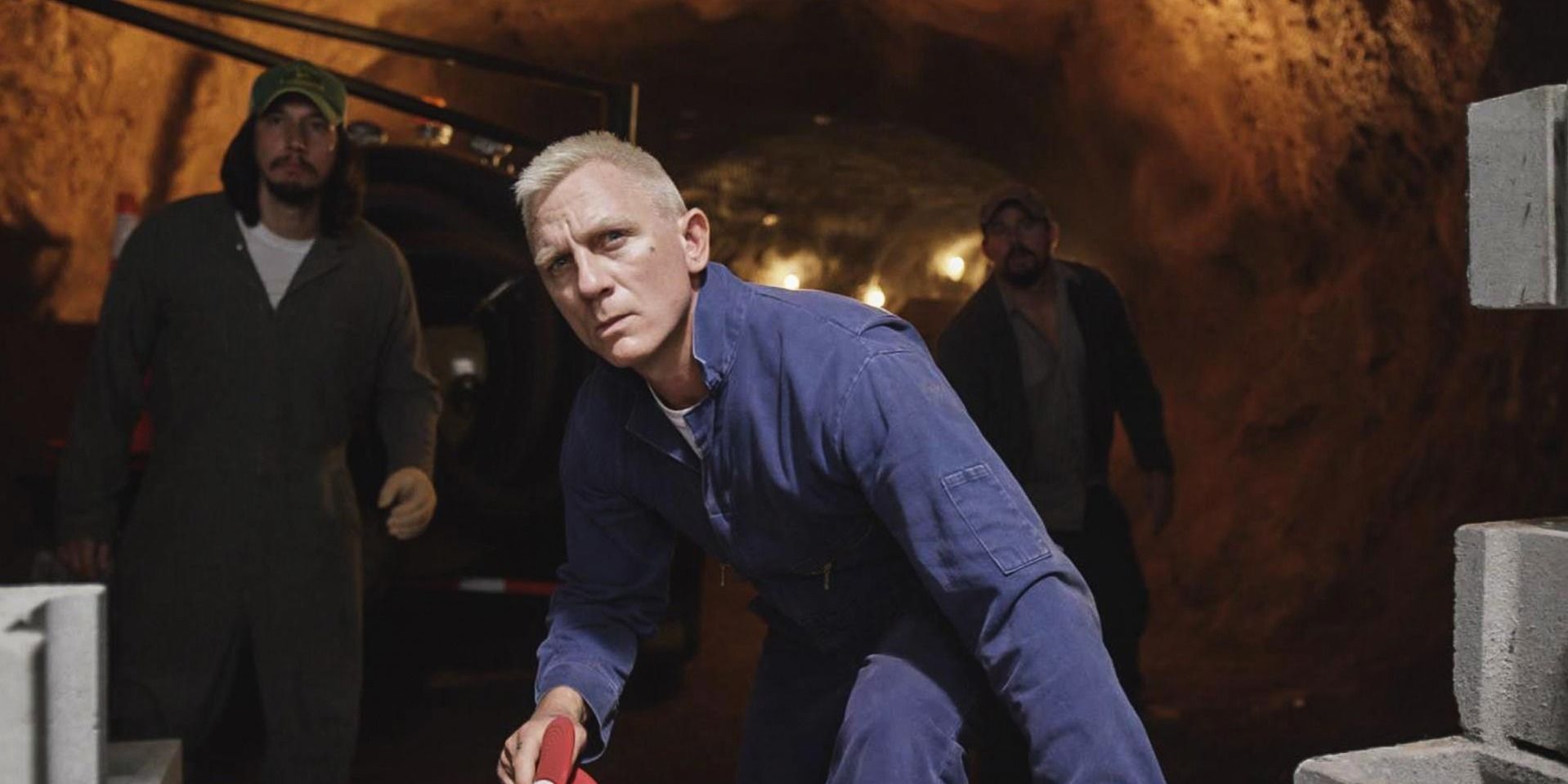 Daniel Craig in a blue jumpsuit in Logan Lucky