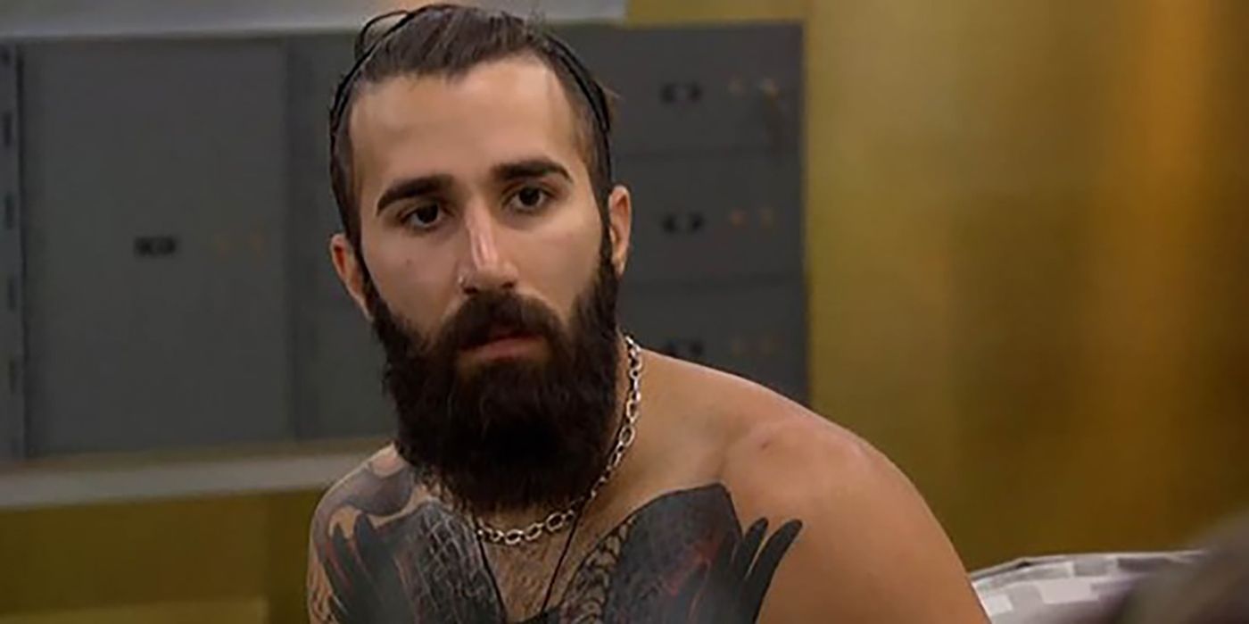 Paul Abrahamian sits with no shirt of on Big Brother 18.