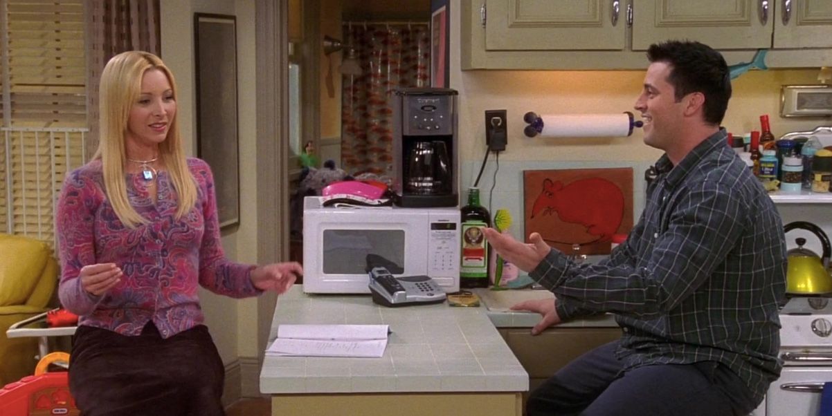 An image of Phoebe and Joey talking in his apartment in Friends