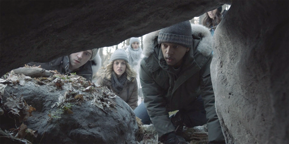 A group of people looking through rocks in Slasher.