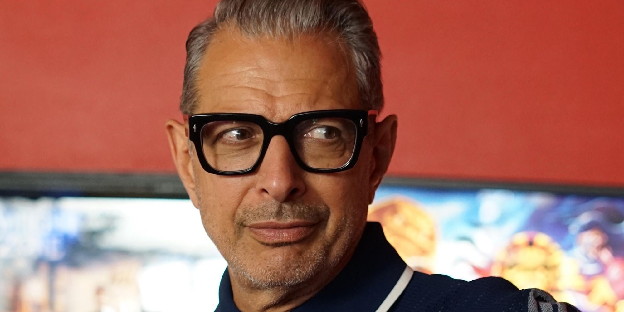 An image of Jeff Goldblum smiling at someone off-screen in the World According To Jeff Goldblum