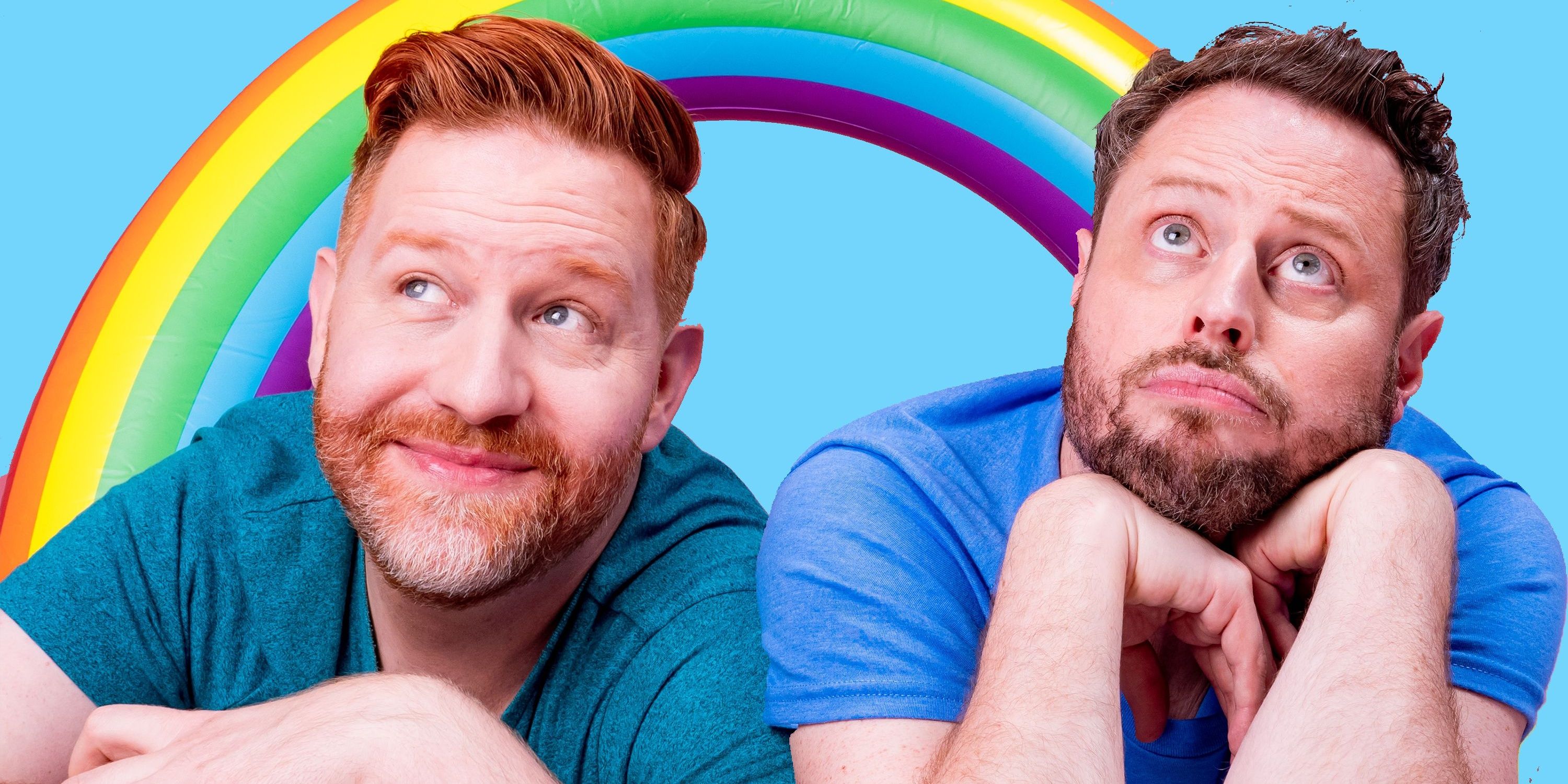 Matt Marr and Jake Anthony of Reality Gays wearing blue shirts and staring away with a rainbow in the background