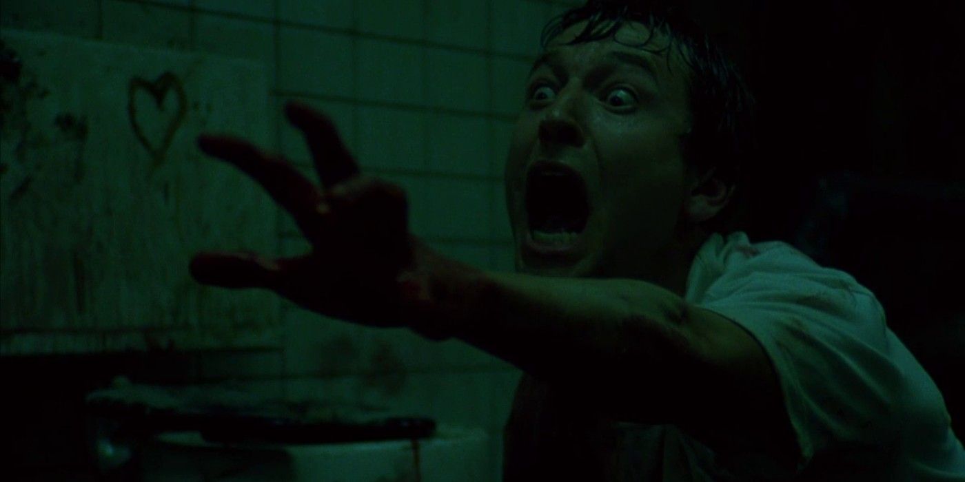 Leigh Whannell as Adam reaching out and screaming at the end of Saw