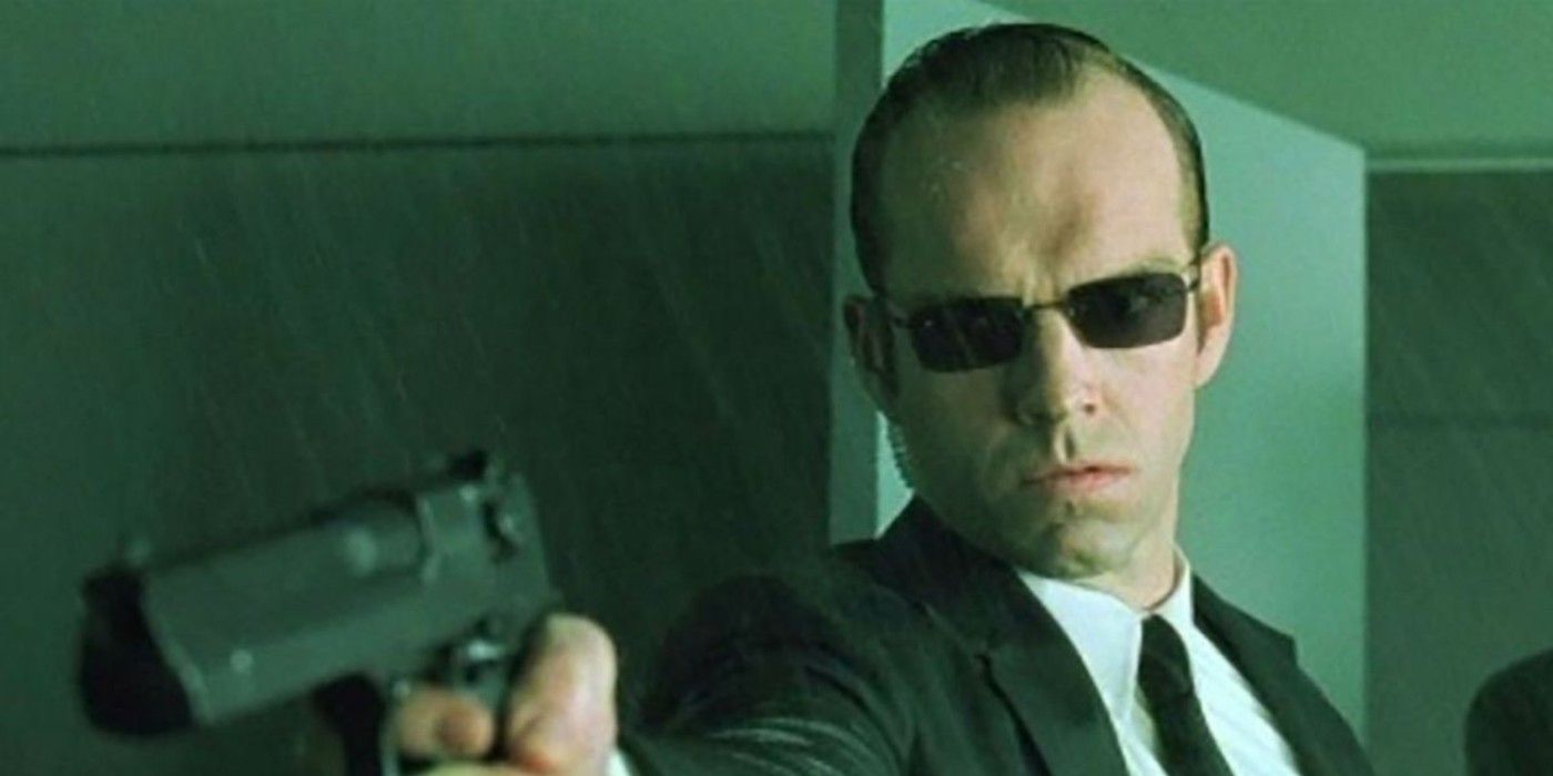 Hugo Weaving as Agent Smith holding a Desert Eagle gun in The Matrix