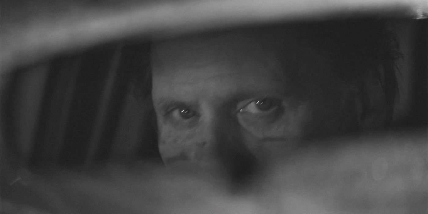 An image of the Taxi driver looking at the camera through the mirror in Better Call Saul