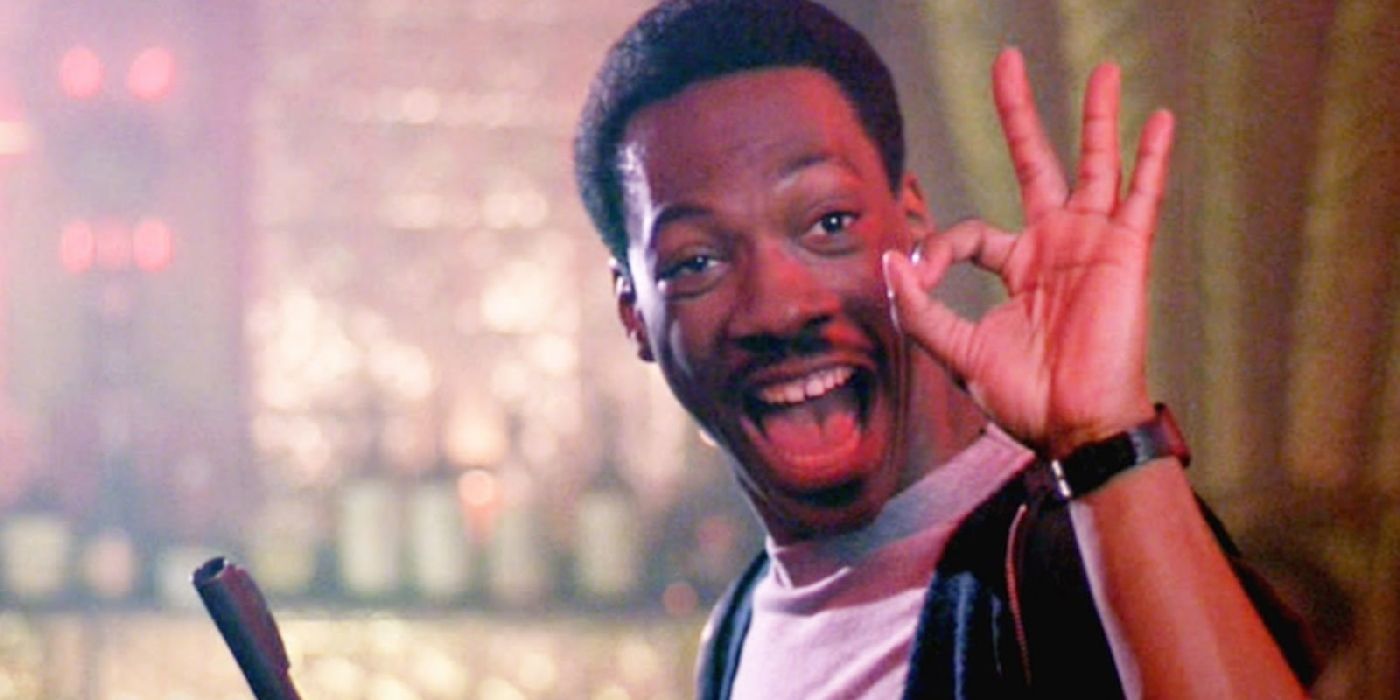 Eddie Murphy smiling and giving the 'okay' sign in Beverly Hills Cop