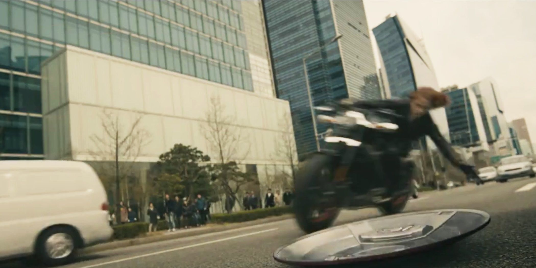 Black Widow picks up Captain America's shield on her motorcycle in Avengers: Age Of Ultron