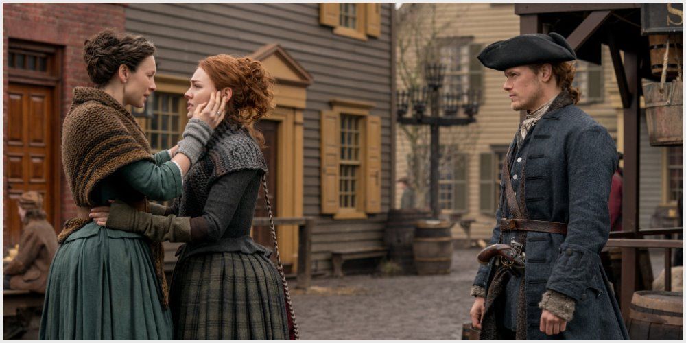 Clair and Brianna embrace as Jamie stands to the side in Outlander 