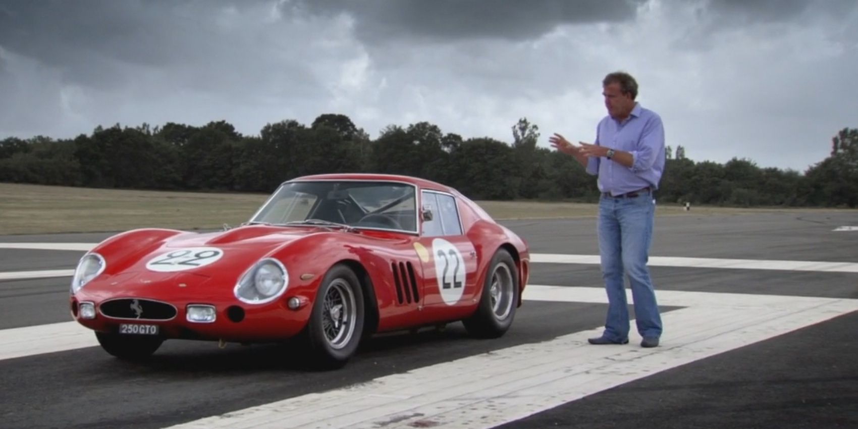 Jeremy Clarkson standing next to a classic Ferrari on the track on Top Gear