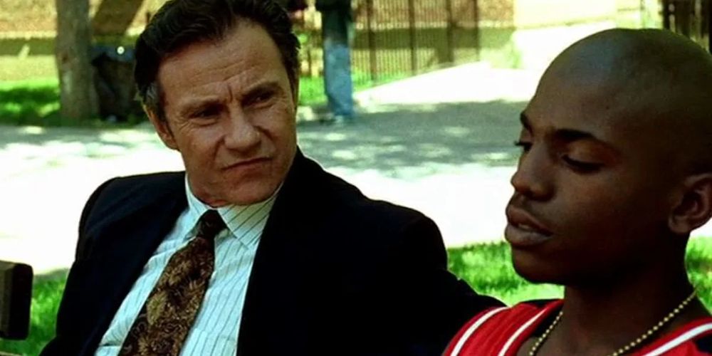 Harvey Keitel and Mekhi Phifer sitting on a park bench in Clockers