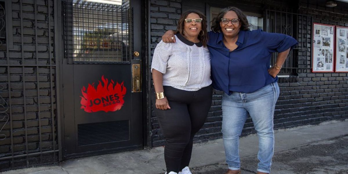 Deborah Mary Jones Queer Eye posing with friend on street