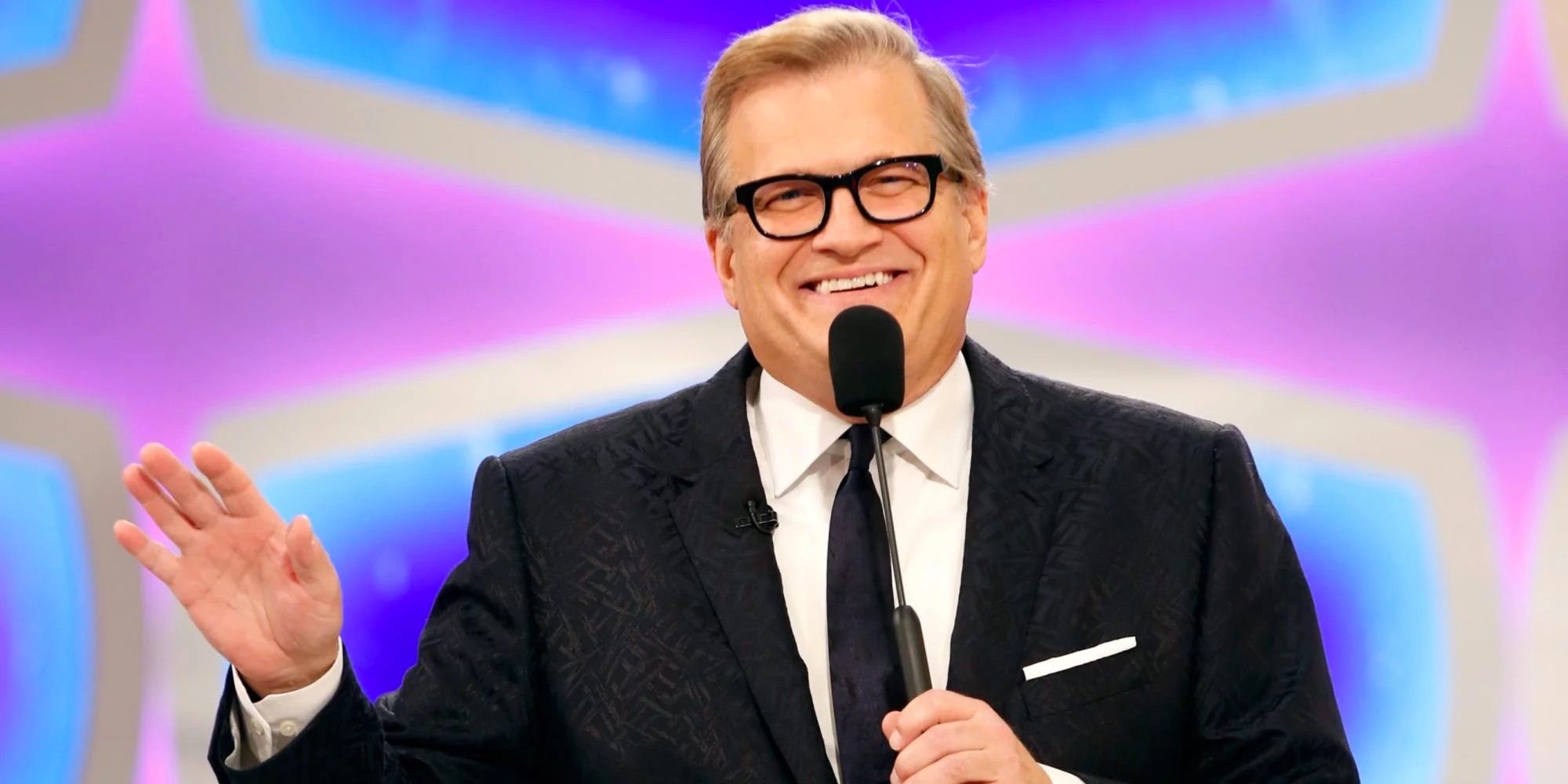 Drew Carey smiles while hosting The Price Is Right.