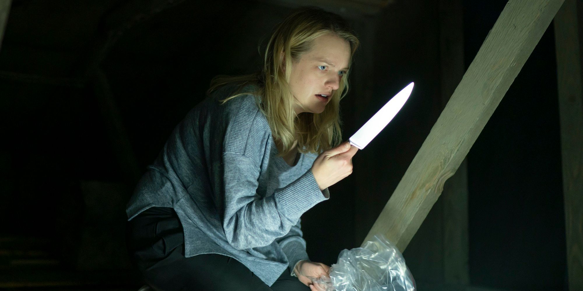 Elisabeth Moss holds a knife in The Invisible Man