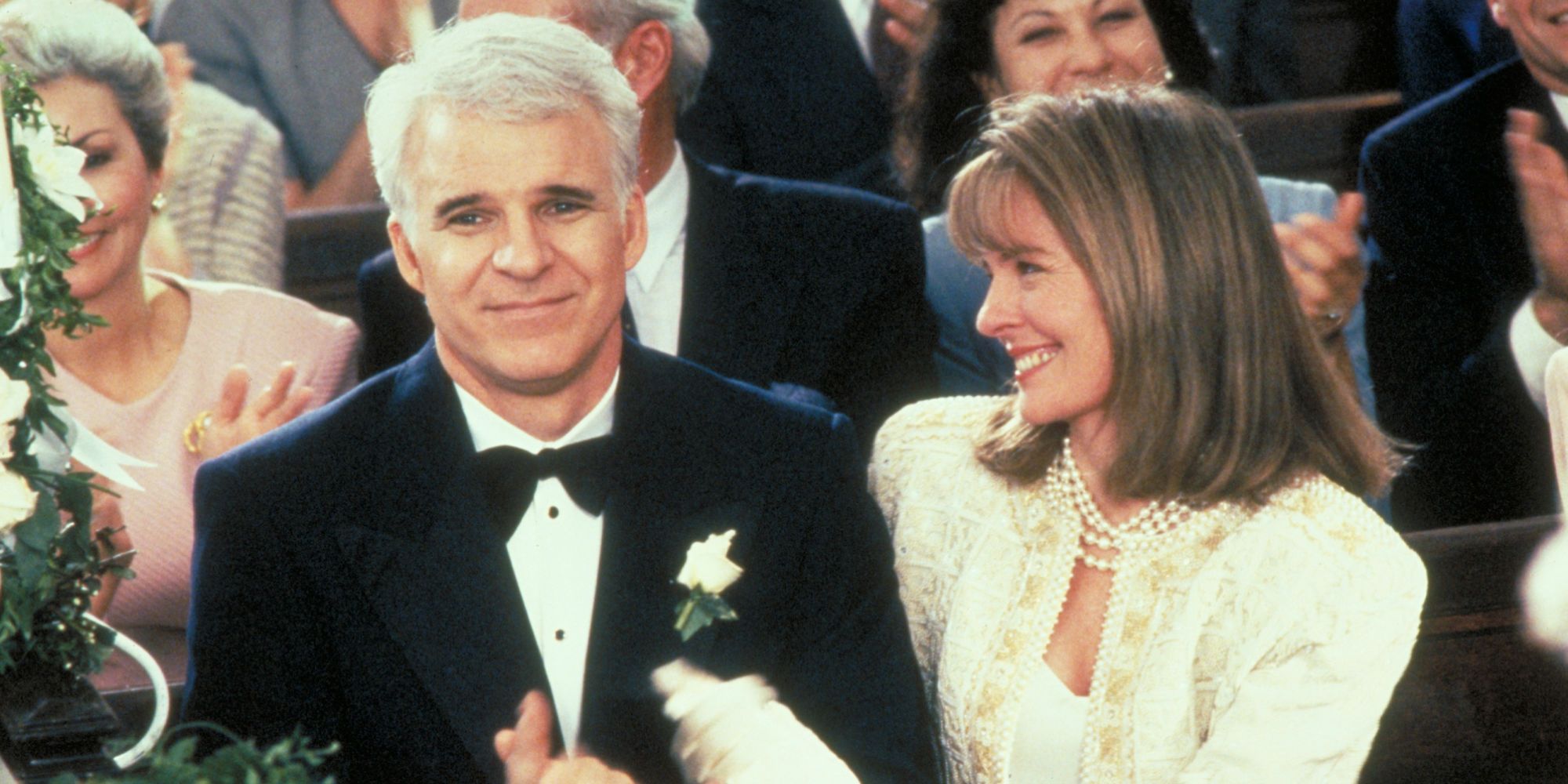 George and Nina sit at their daughter's wedding in Father of the Bride