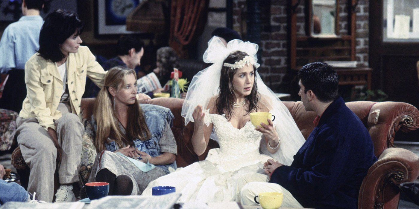 Rachel in her wedding dress talking to Phoebe, Ross, and Monica at Central Perk in Friends.
