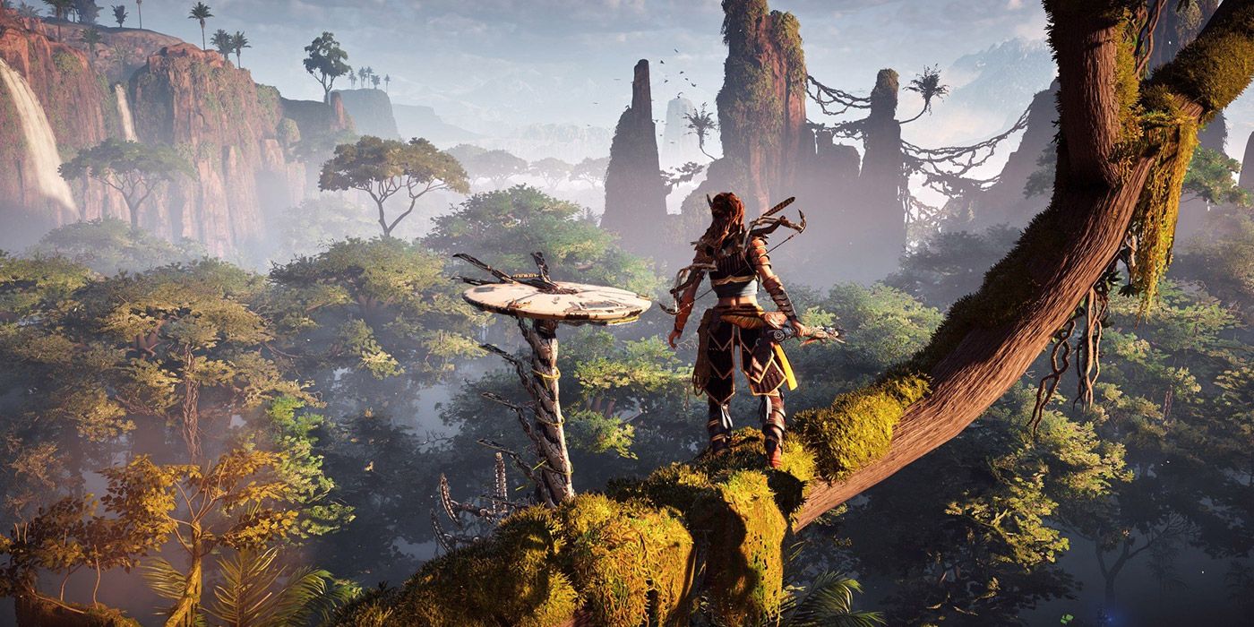 A wide shot of a main character standing on a tree branch overlooking a jungle vista from Horizon Zero Dawn in HDR format