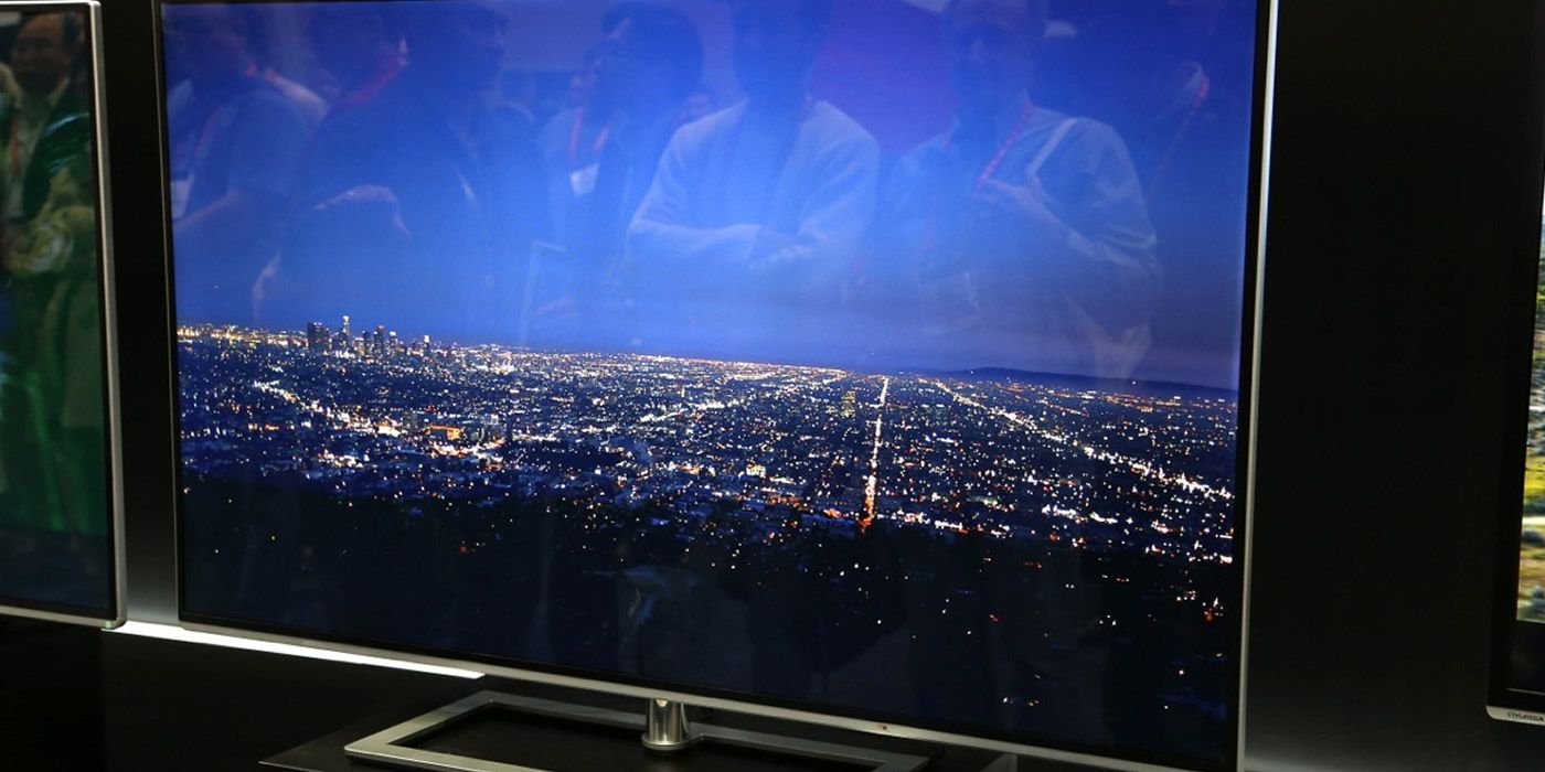 A 65&quot; 4K HDR TV at a technology show showing a city at night