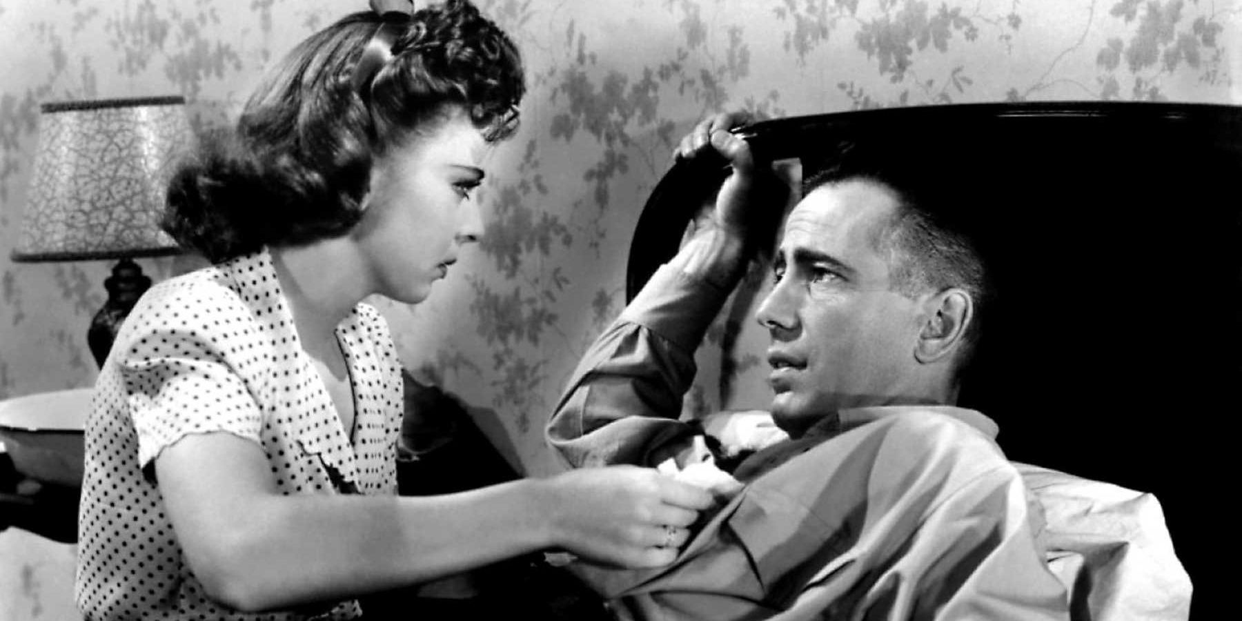 Humphrey Bogart in a bed being tended to by Ida Lupino in High Sierra.