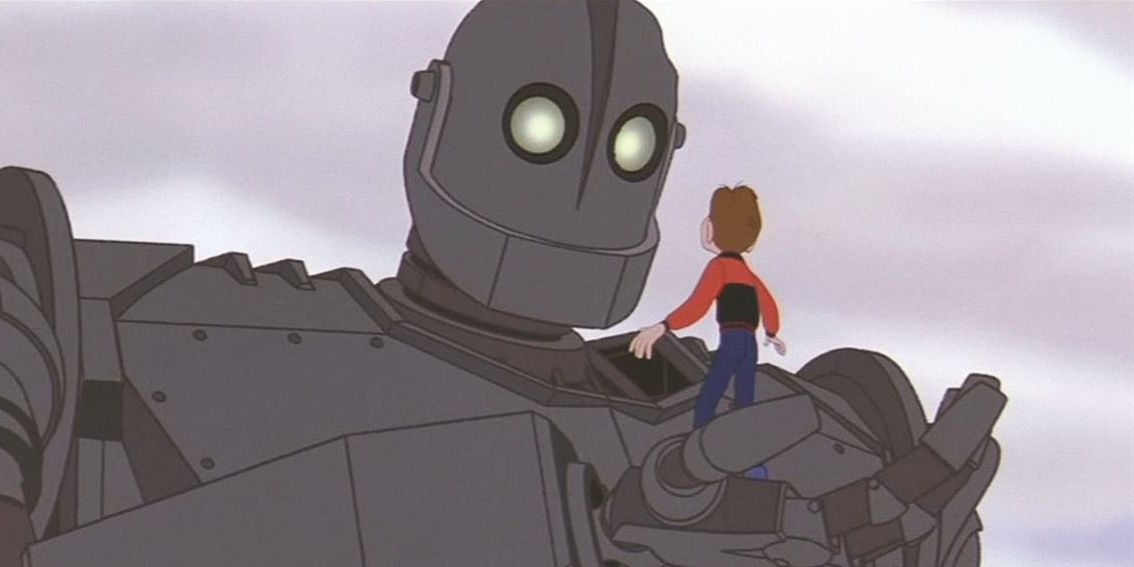 The Iron Giant holding Hogarth in his hand in The Iron Giant (1999)