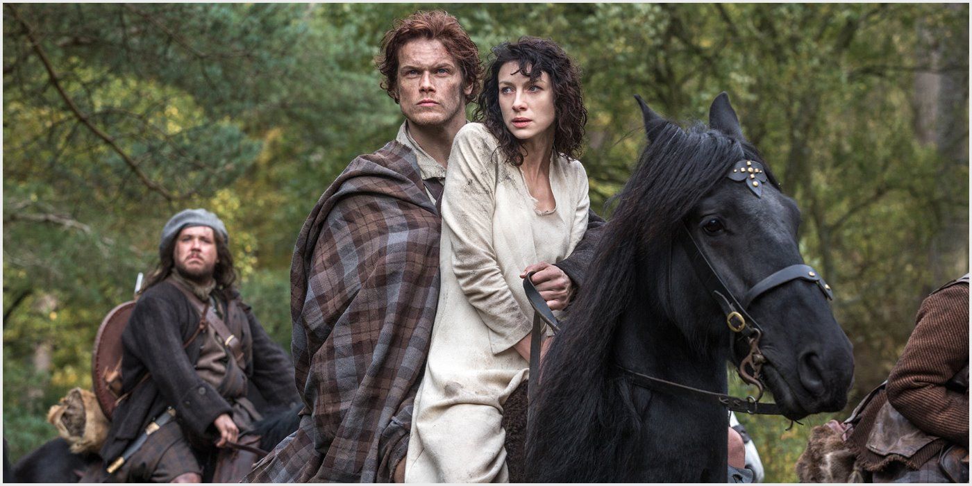 Jamie and Claire riding a horse on Outlander.