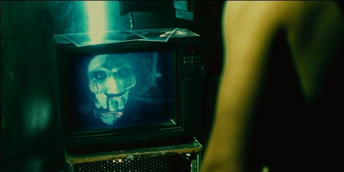 The Billy puppet on a television screen in Saw 2.
