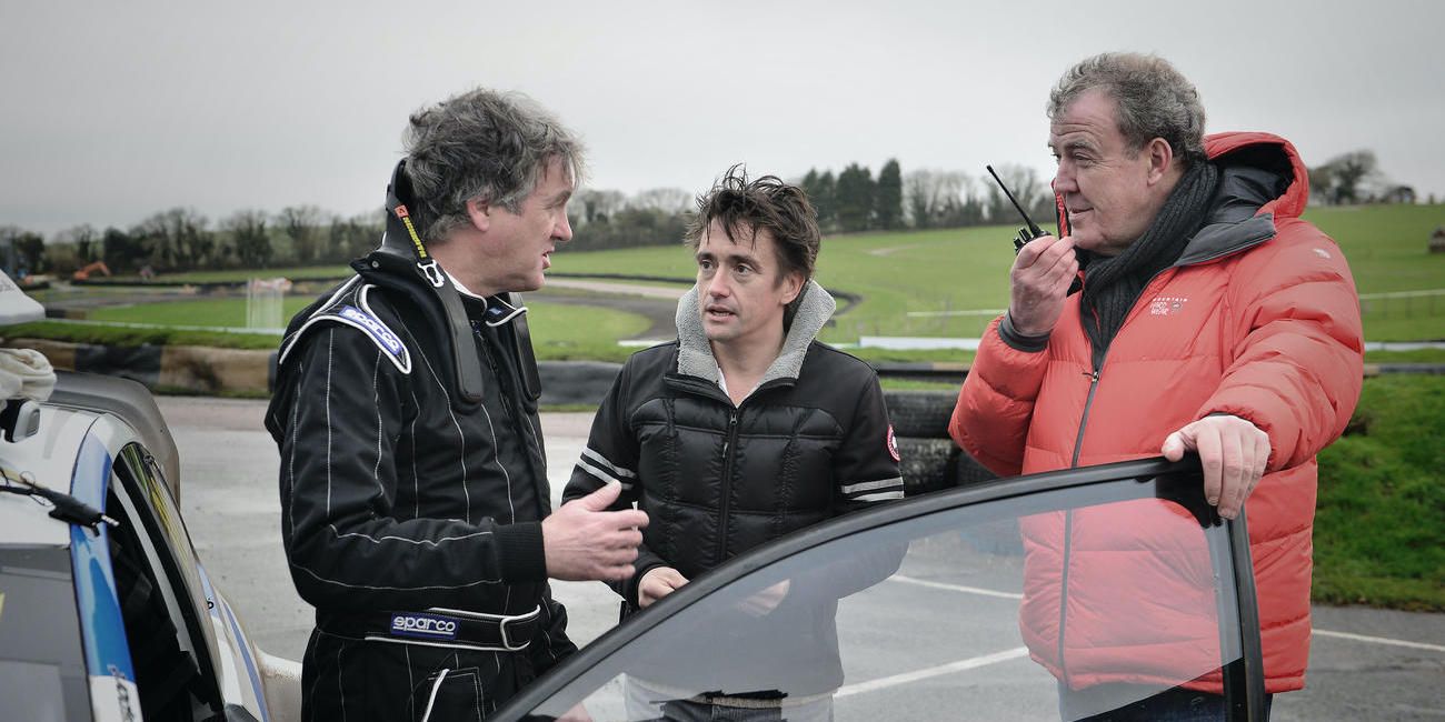 James May, Richard Hammond and Jeremy Clarkson talking around a car on the track in Top Gear