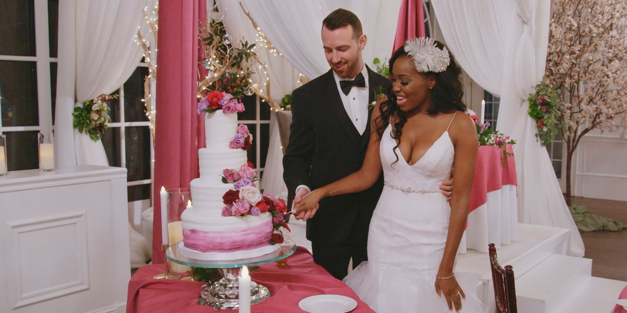 Cameron and Lauren standing next to their cake on their wedding day on Love Is Blind
