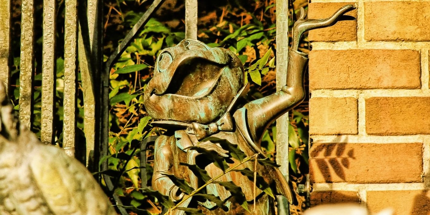 A rusted metal statue of Mr. Toad