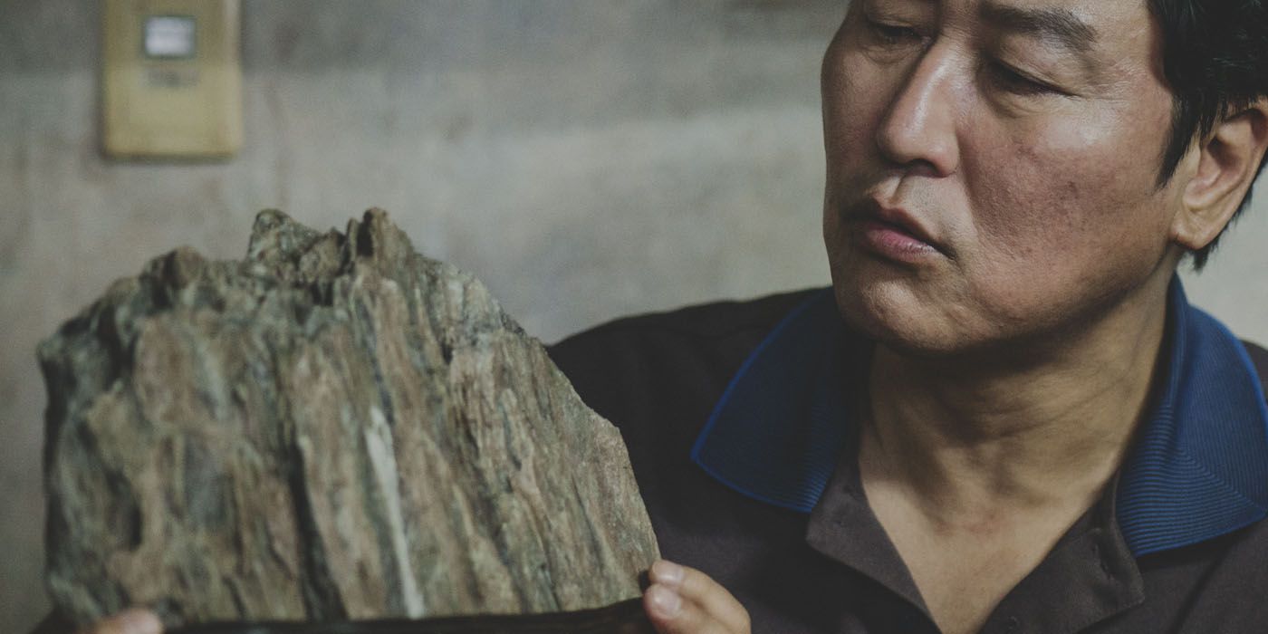 Placeholder for Image: The scholar’s rock sitting on a table. Caption: "The scholar’s rock symbolizes both hope and the heavy burden of societal expectations."