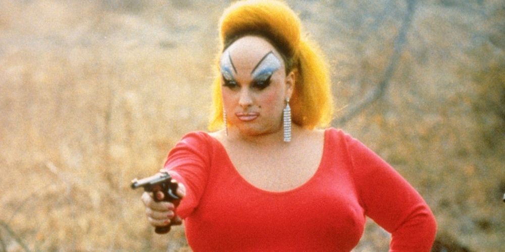 Divine holds a gun in the climax of Pink Flamingos.