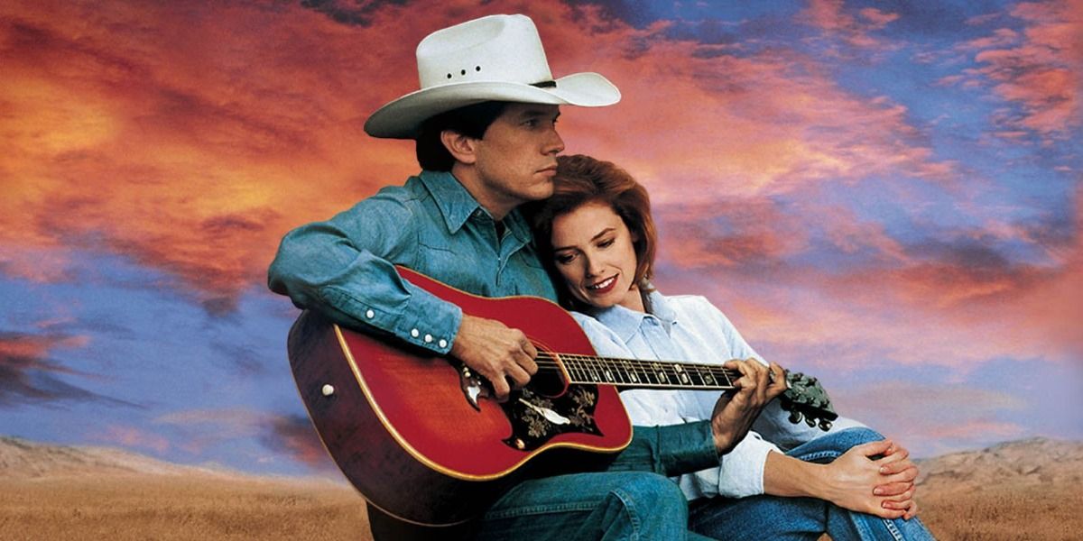 George Strait plays a guitar while a woman listens from Pure Country