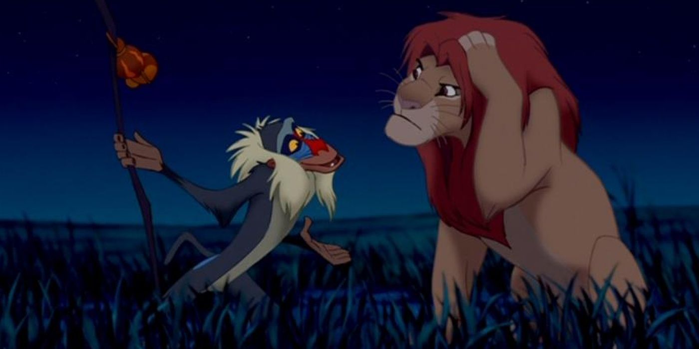 Rafiki standing by Simba after bashing his head