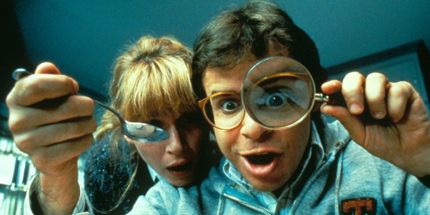 Wayne and Amy look with magnifying glasses in Honey, I Shrunk the Kids