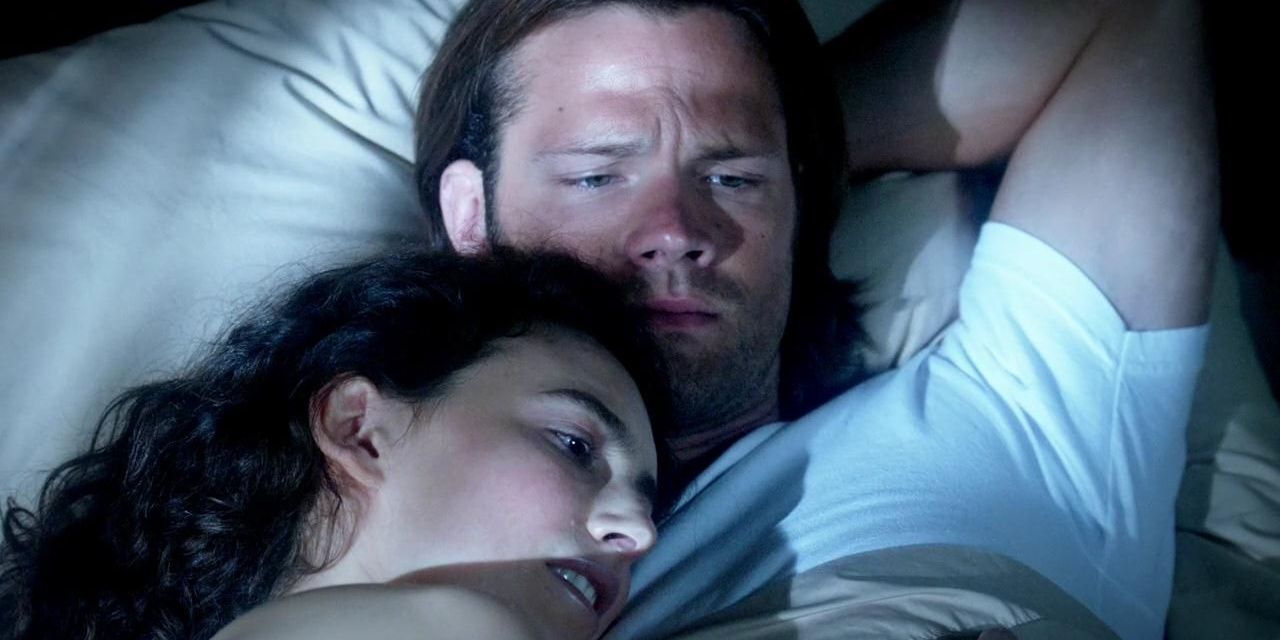 Sam and Amelia lay in bed with one another in Supernatural