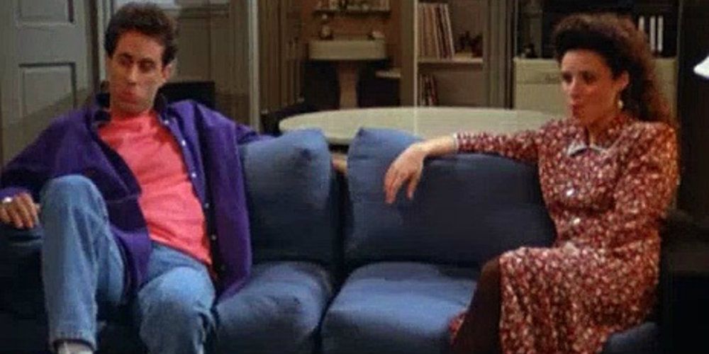 Jerry and Elaine sitting on a couch together in Seinfeld