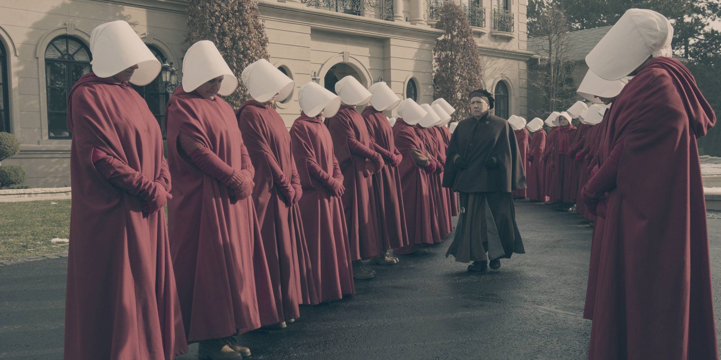 Aunt Lydia walking among the handmaids in The Handmaid&rsquo;s Tale