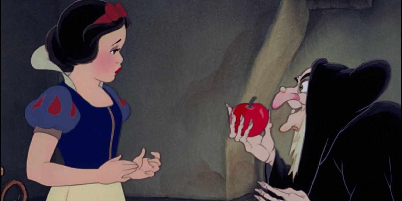 Snow looking at the evil queen's apple in Snow White