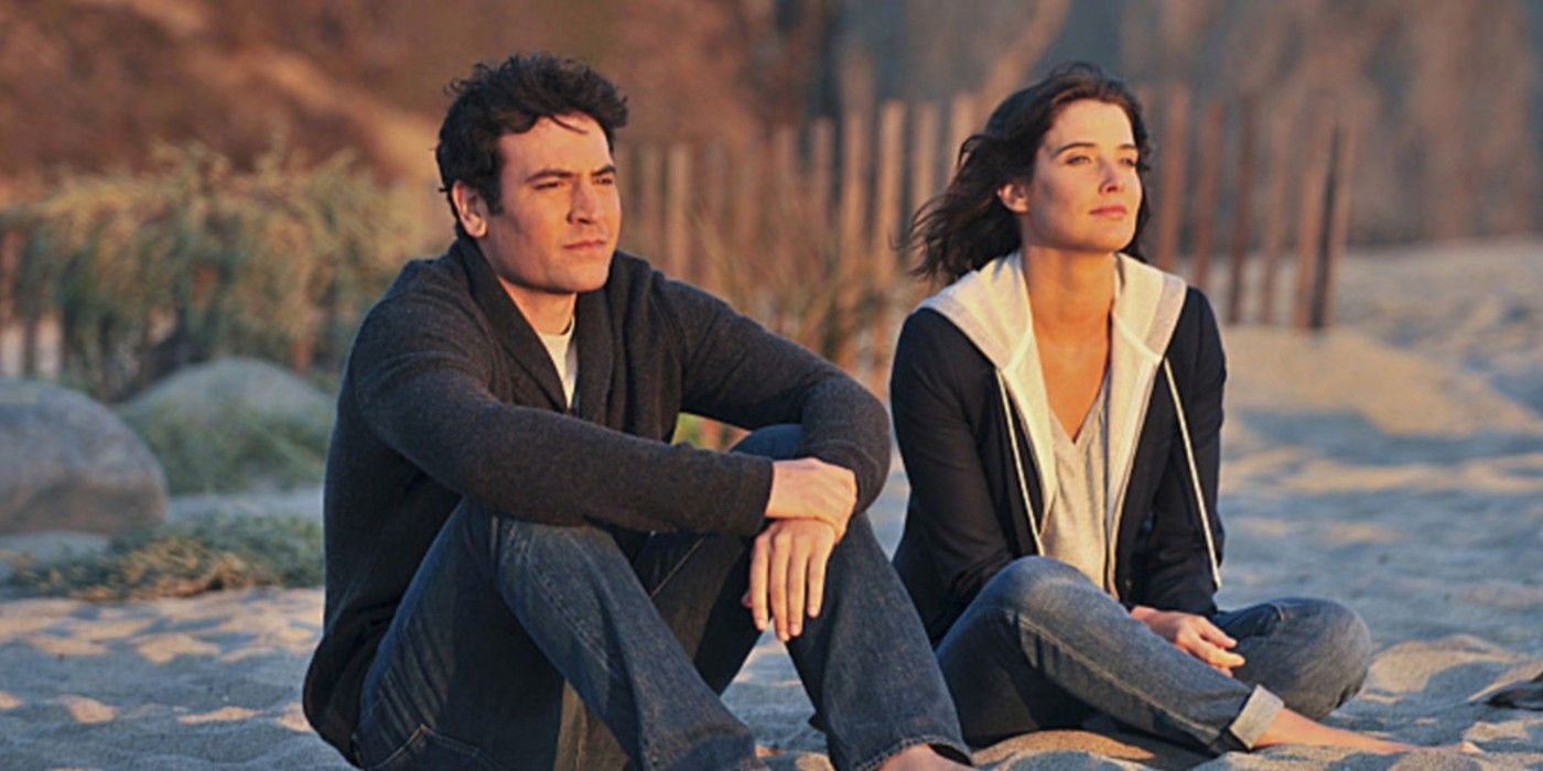 Ted and Robin sitting on the beach in How I Met Your Mother