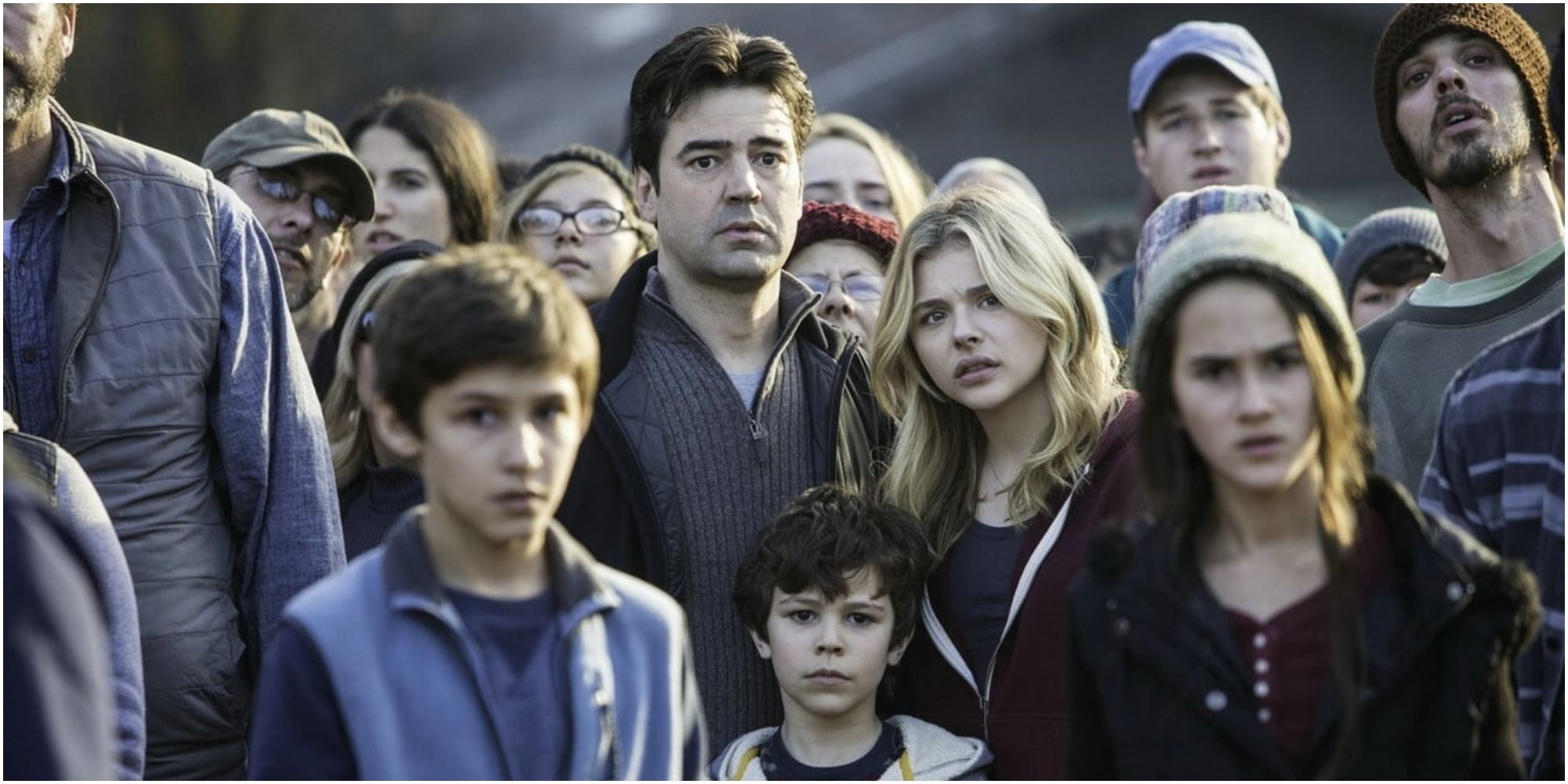 Zackary Arthur stands next to Chloe Grace Moretz in the 5th Wave