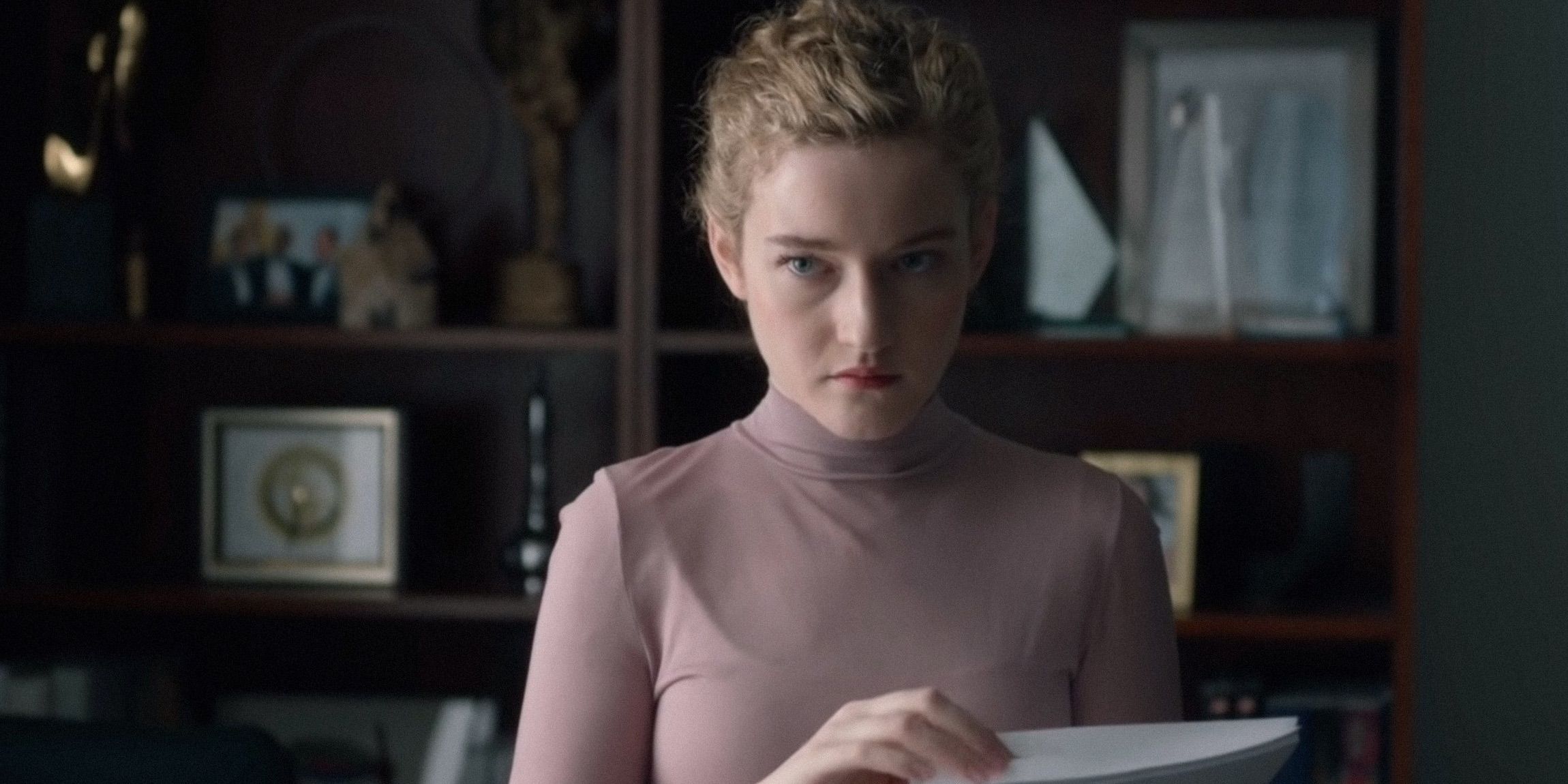 Julia Garner flipping through pages in The Assistant 