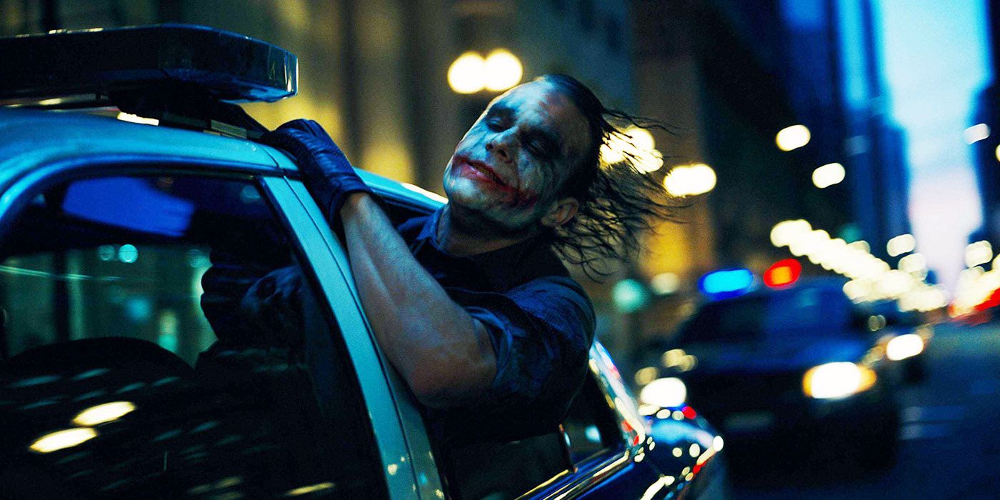 The Joker hanging from a police car in The Dark Knight