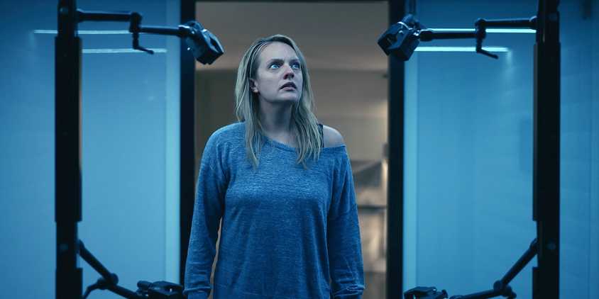 Elizabeth Moss looks at the invisibility apparatus in The Invisible Man