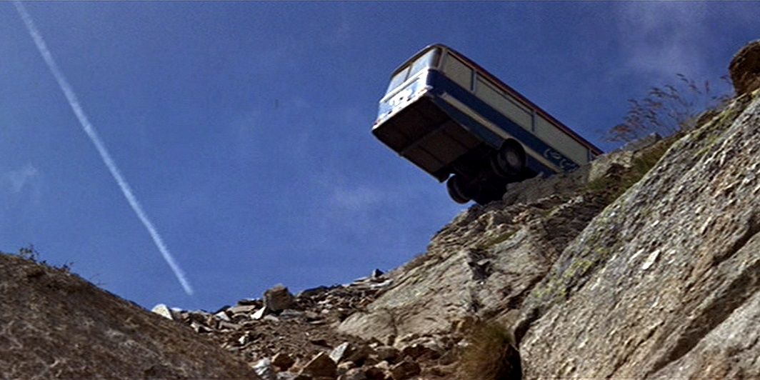 A bus balances on the edge of a cliff in The Italian Job