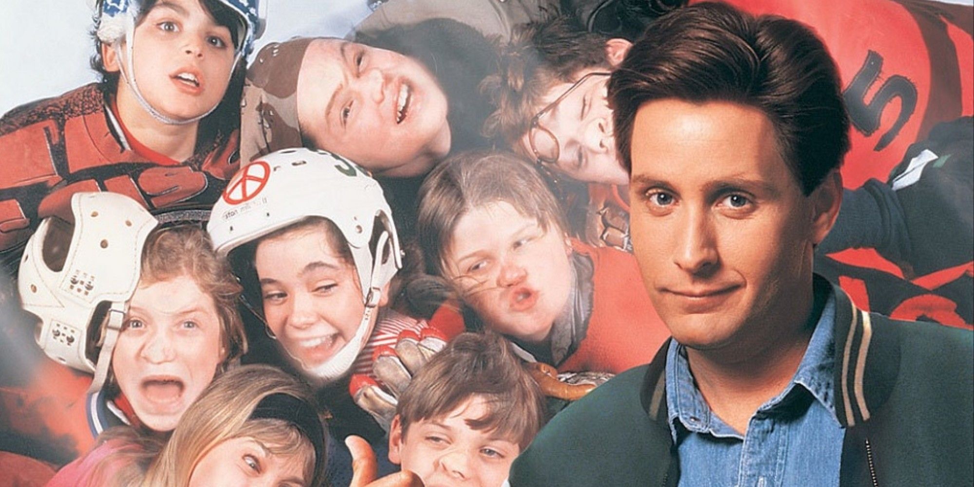 The Mighty Ducks 1992 poster with Emilio Estevez in the foreground and several actors who make up the hockey team pressed up against the glass behind him