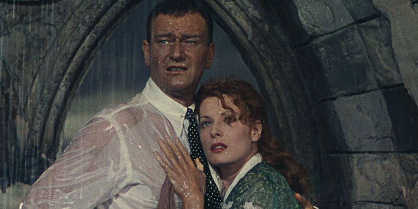 two main characters stand soaked in an archway in The Quiet Man