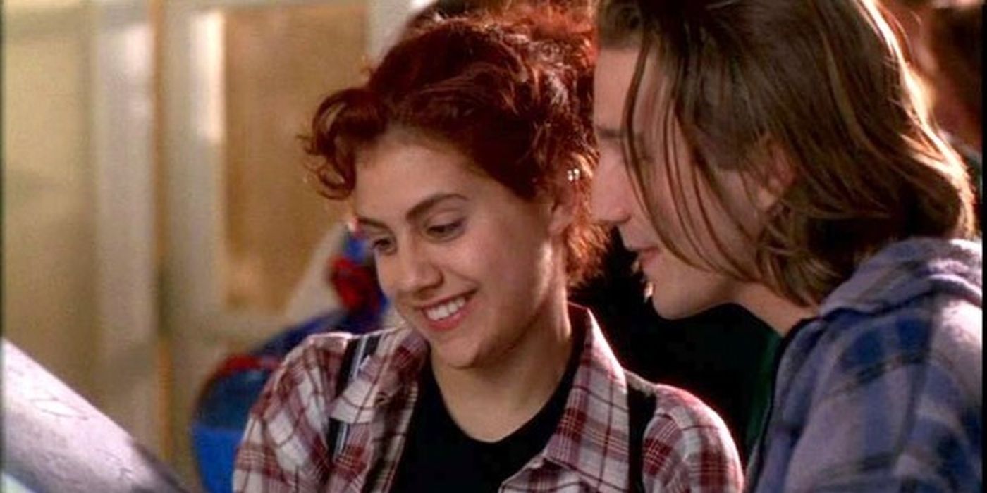 Tai smiles while showing Travis her drawings in Clueless