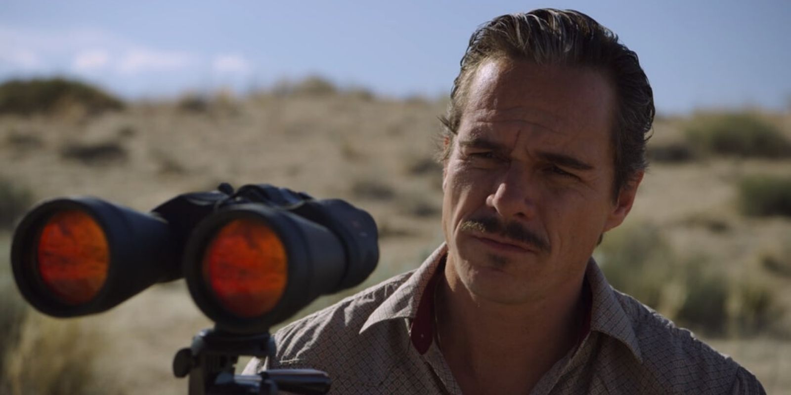 Lalo Salamanca has a pair of binoculars out in the desert in Better Call Saul
