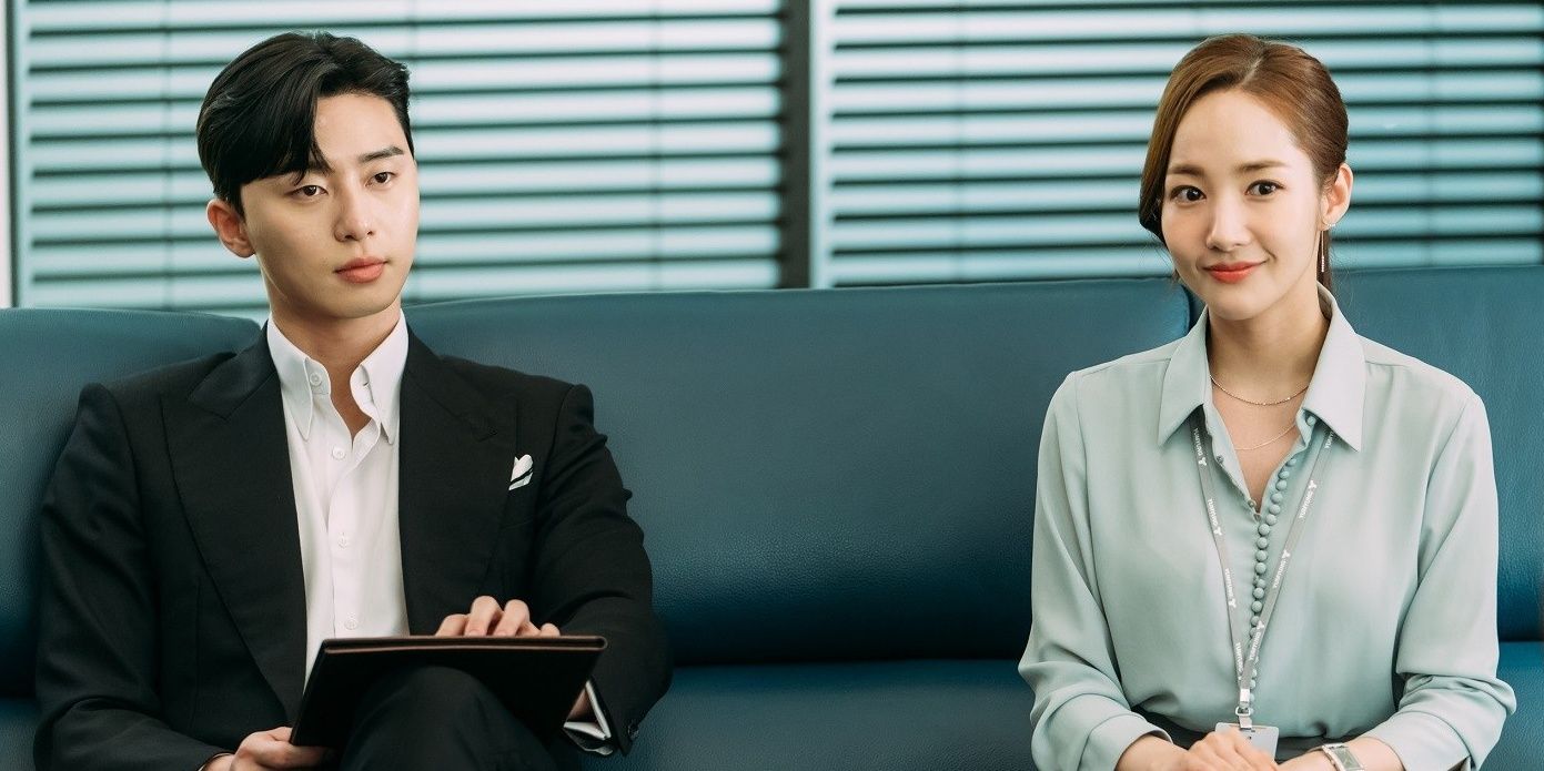 A young man and woman sitting next to each other in the K drama What's Wrong With Secretary Kim.
