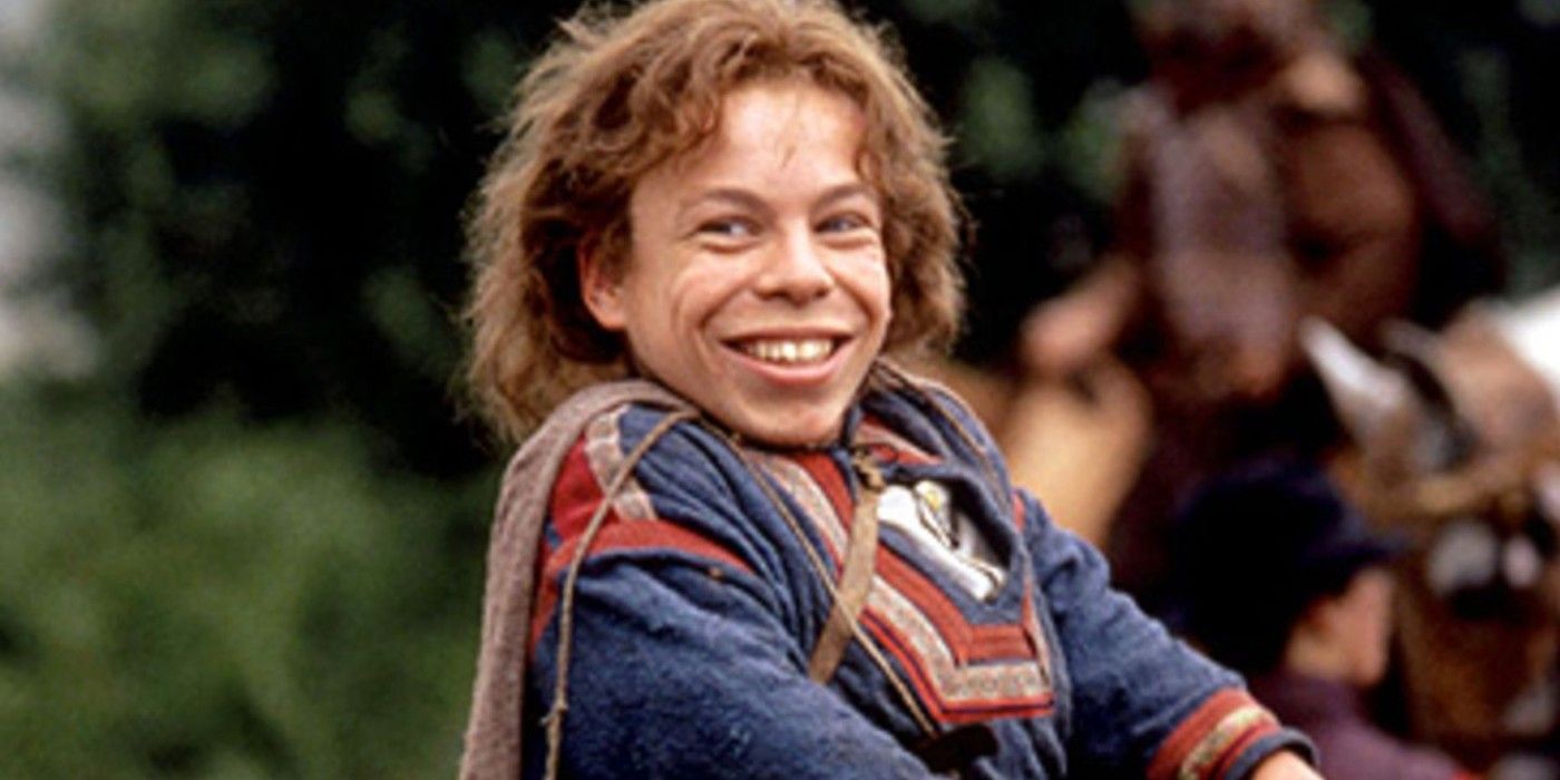 Warwick Davis smiles while looking on in Willow
