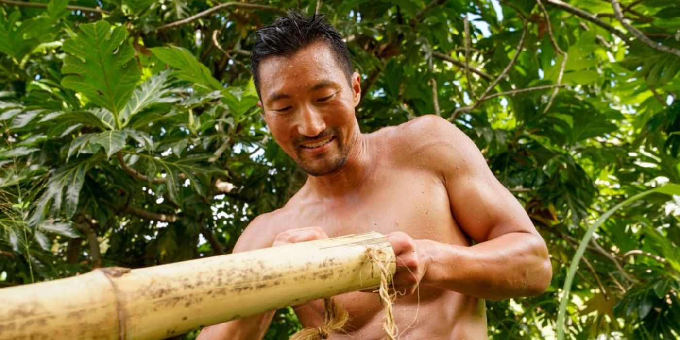 Yul Kwon on Survivor Winners At War posing with bamboo
